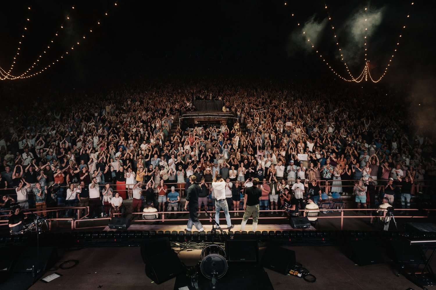 The band taking a bow at the end of the night, the whole room on its feet in front of them
