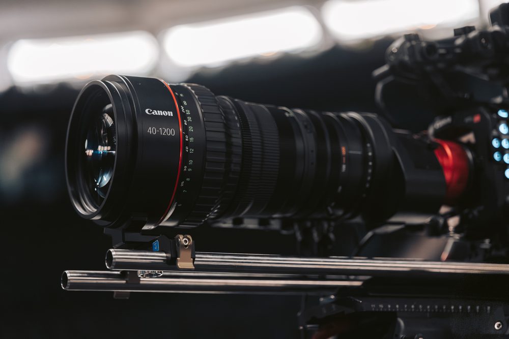 Cinema lenses racked on a slider in an empty arena